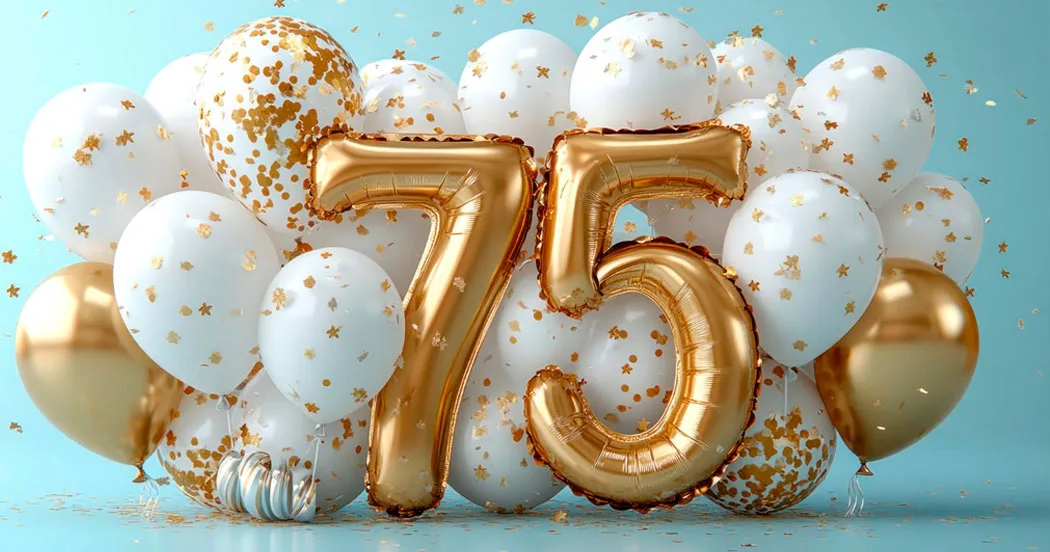Luftballons umrahmen die Szene, während in der Mitte die Zahl 75 aus Luftballons geformt ist.
